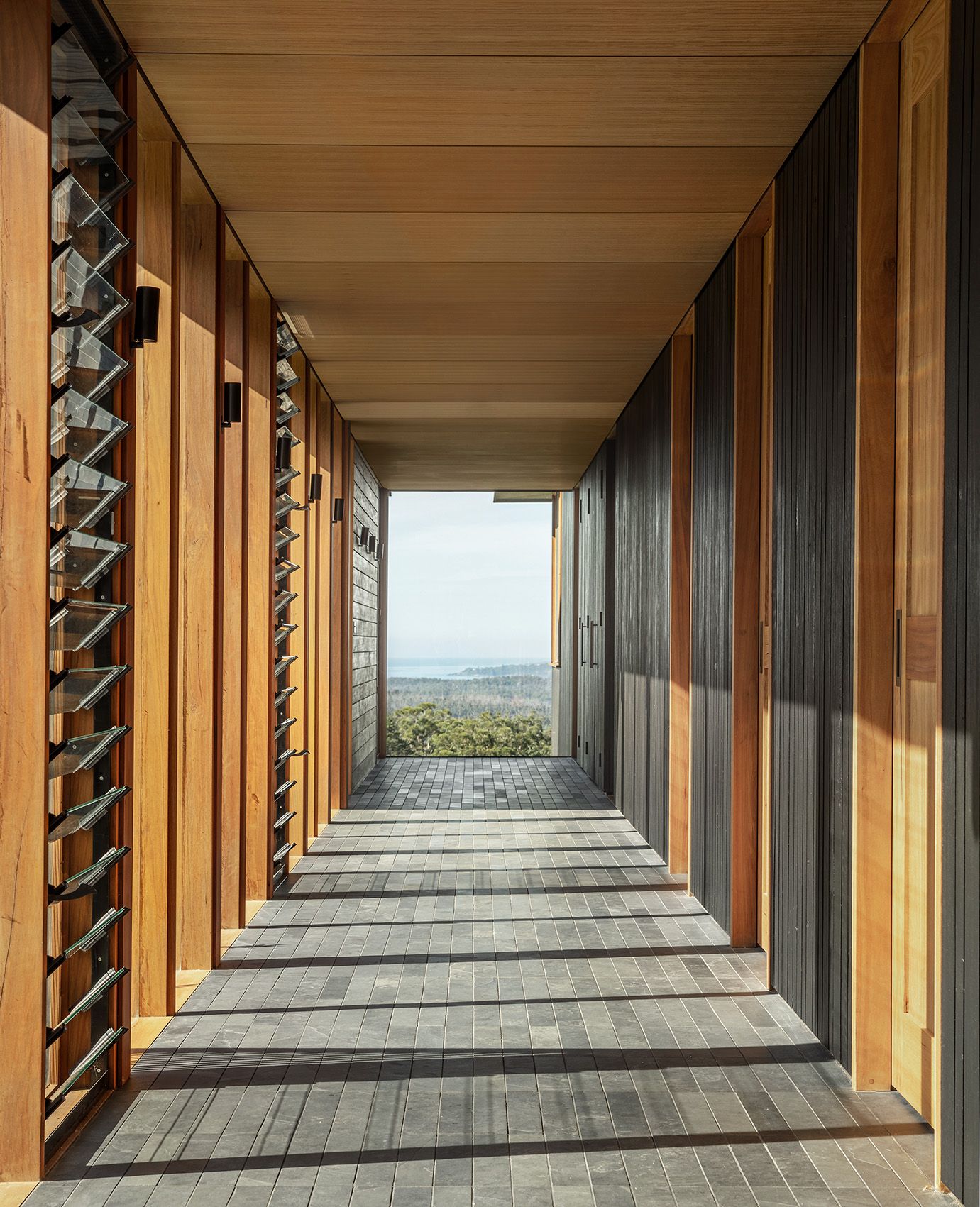 Timber and glass breezeway framing a view to the coast