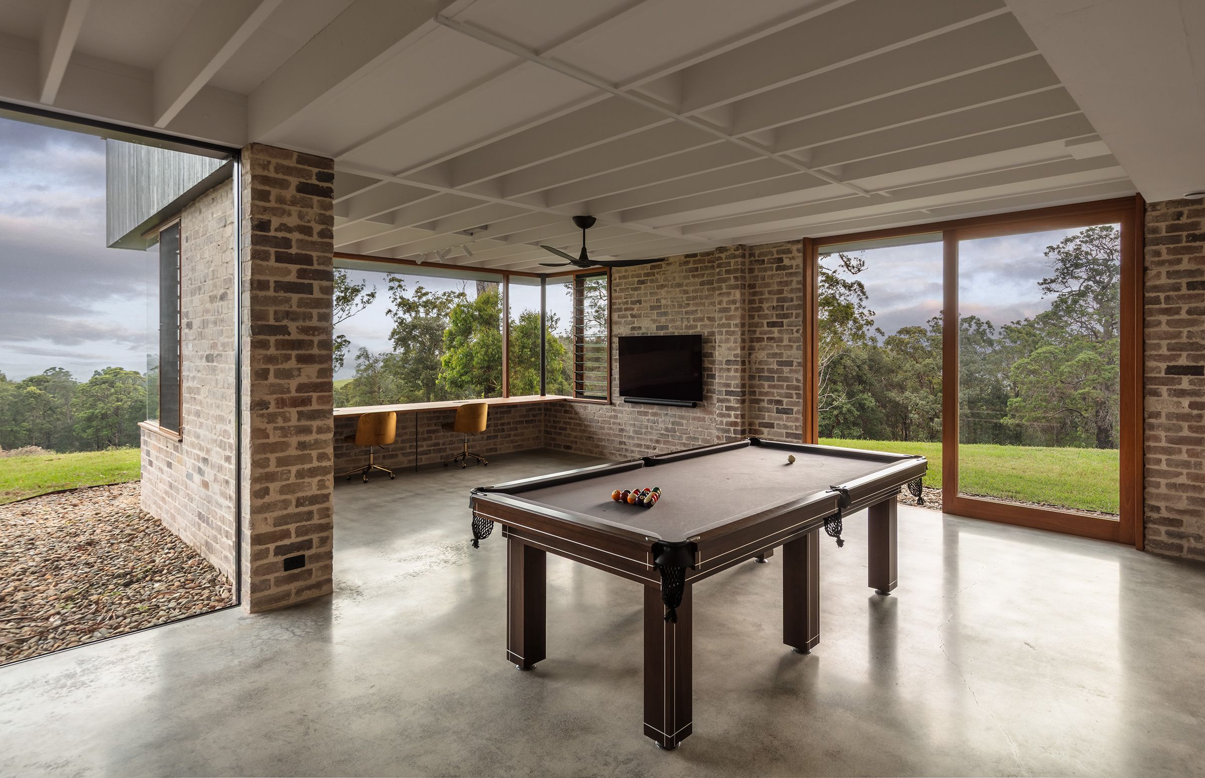 Rumpus room with a billiard table and brick walls