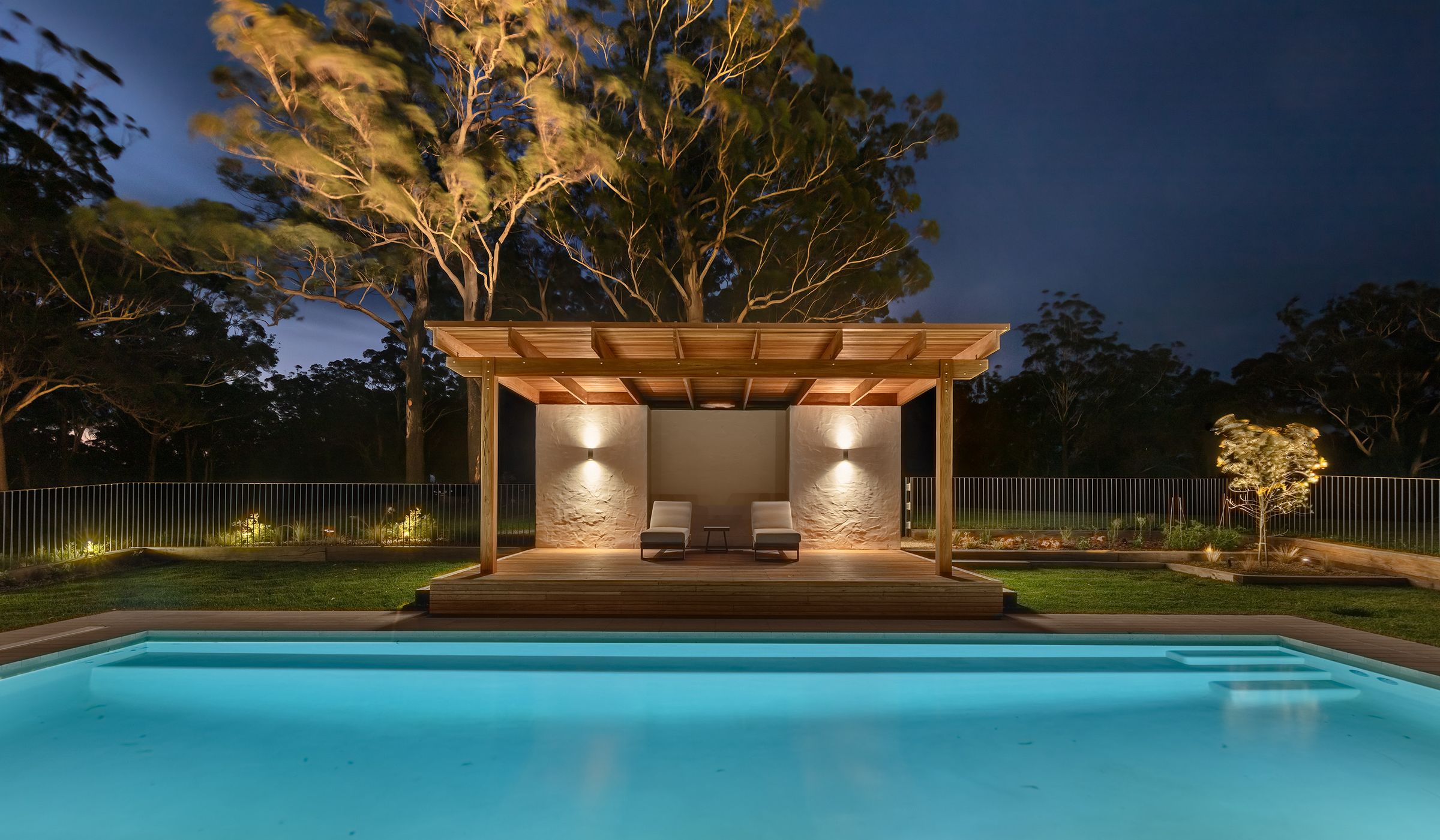 The pool and cabana lit at night