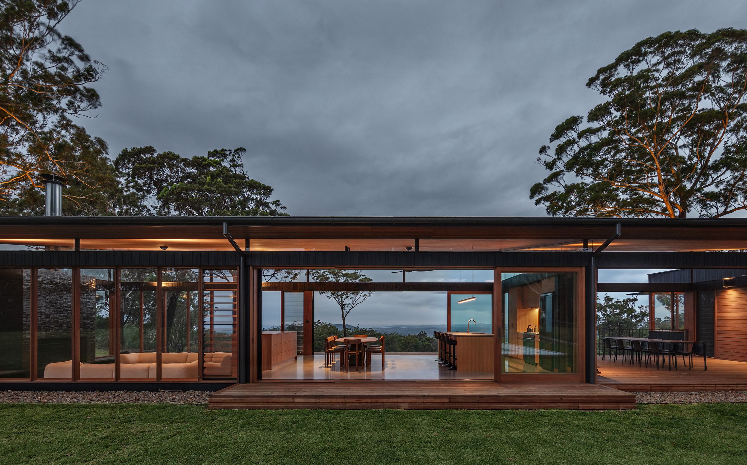 The open pavilion at dusk, looking through the living spaces to the coast