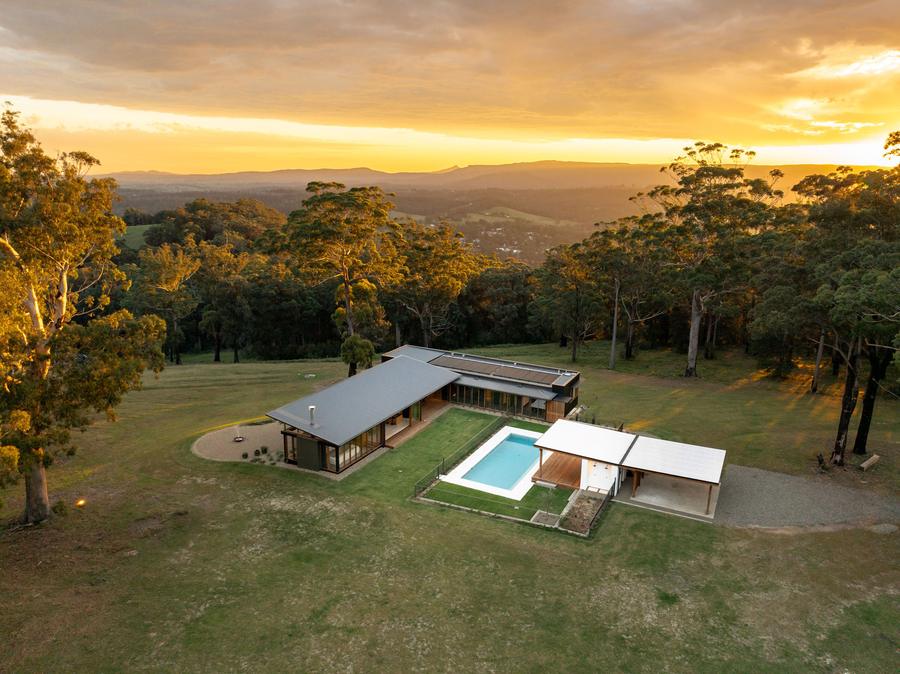 The house and pool from above at sunset