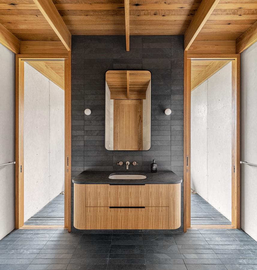 Bathroom vanity in dark tile and timber