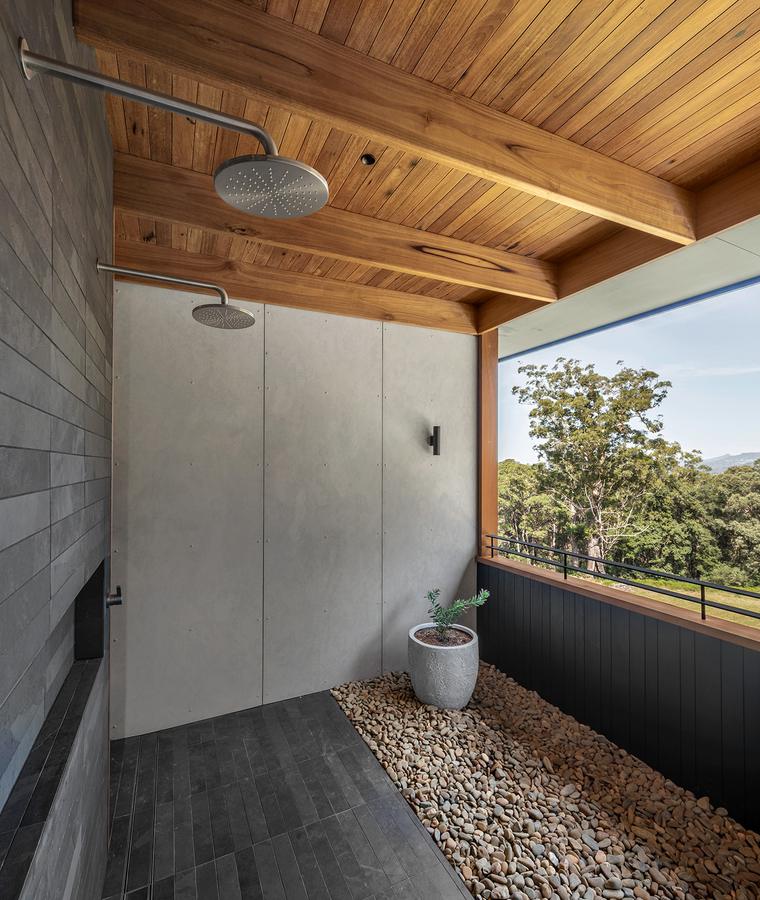 Outdoor shower on a pebble floor
