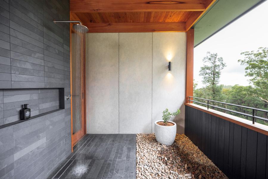 Shower opening to the bush on a pebble floor