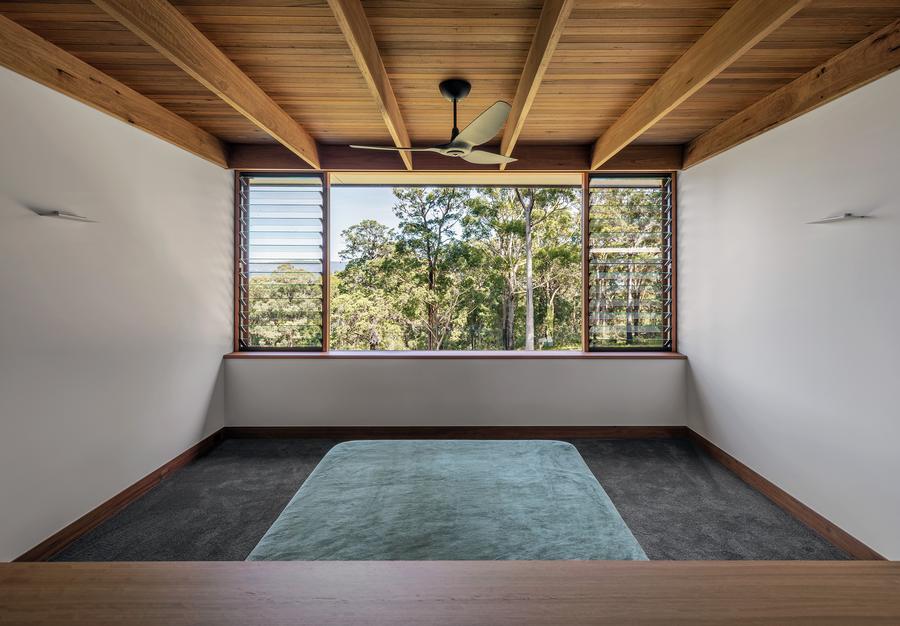 Guest bedroom framed by the treeline