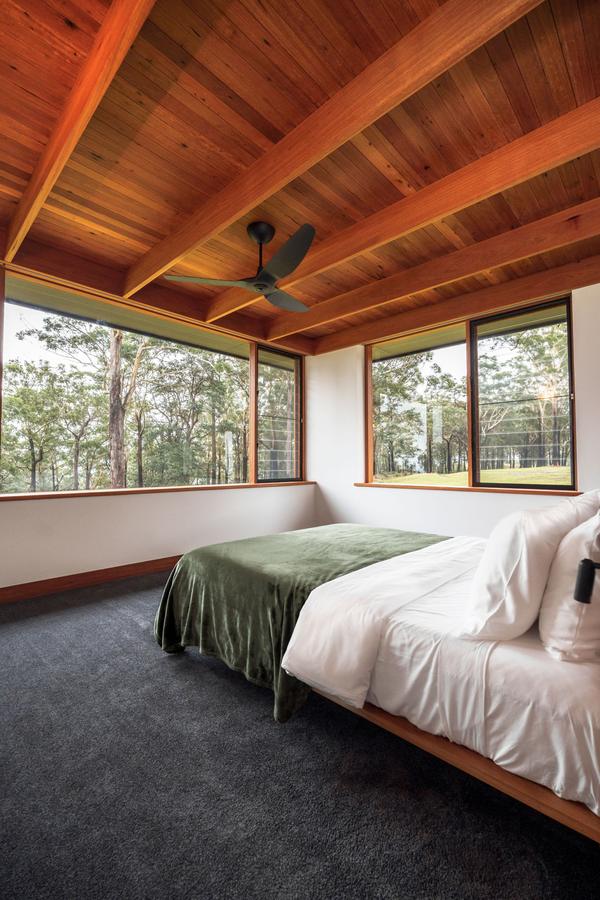 Guest bedroom under a timber ceiling
