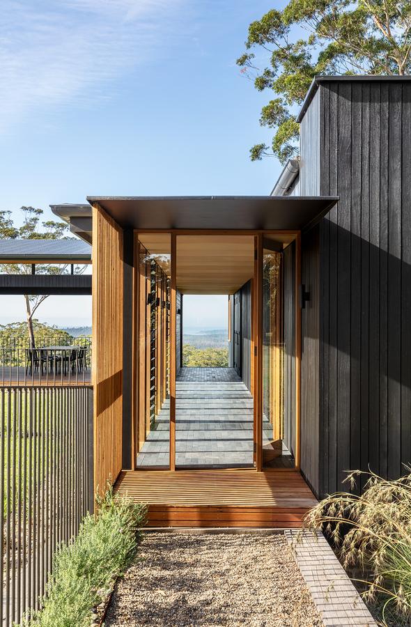 Entry walkway between charcoal walls