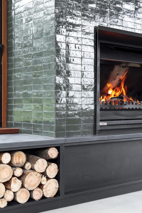 The fireplace with its log store