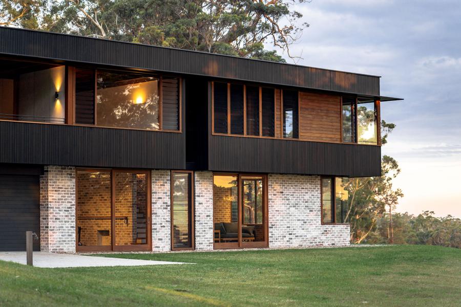 The brick and timber wing glowing at dusk