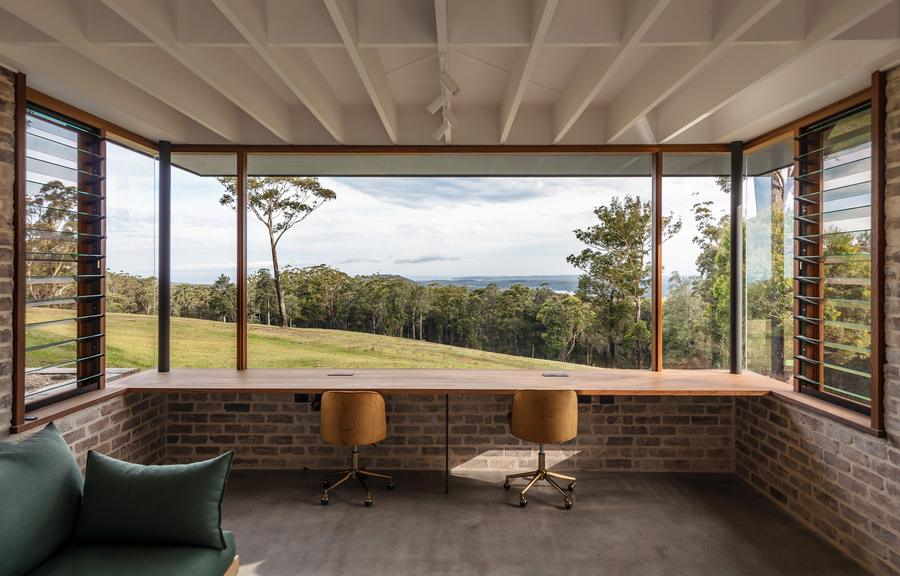 Study desk under a wide window to the view