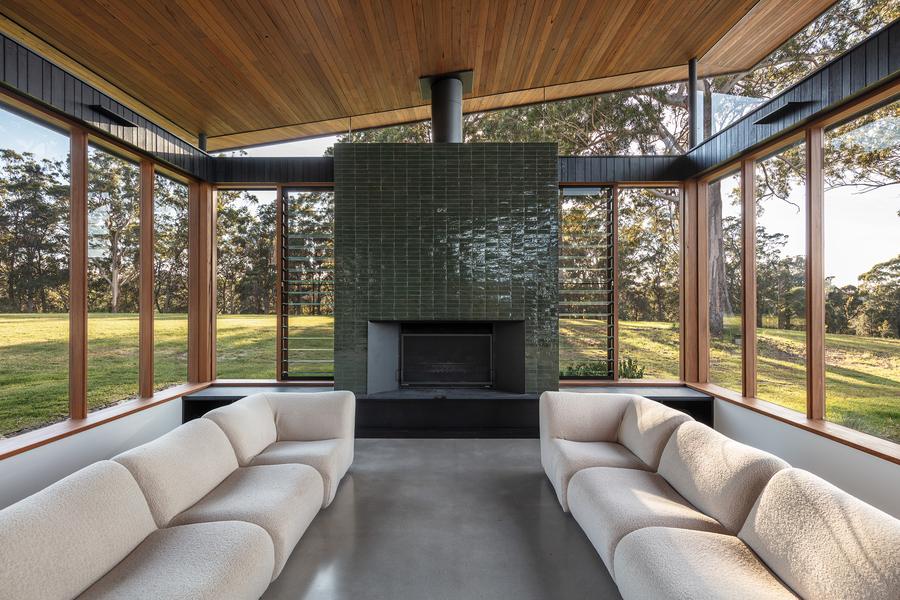 Lounge around the green tiled fireplace, glass on three sides
