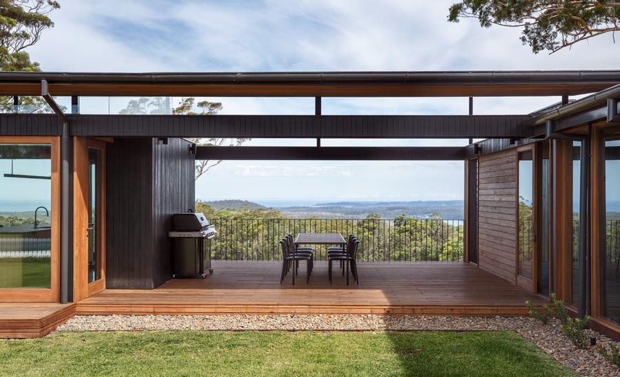 Covered outdoor dining deck with views to the coast