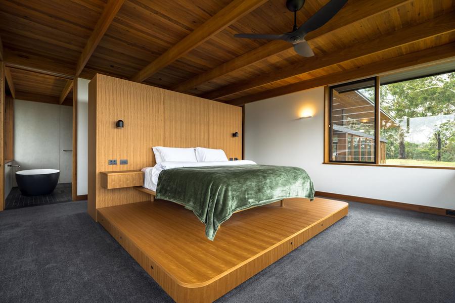 Master bedroom with the bed on a timber platform