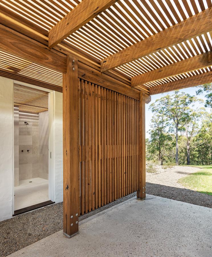 Cabana outdoor shower behind timber battens
